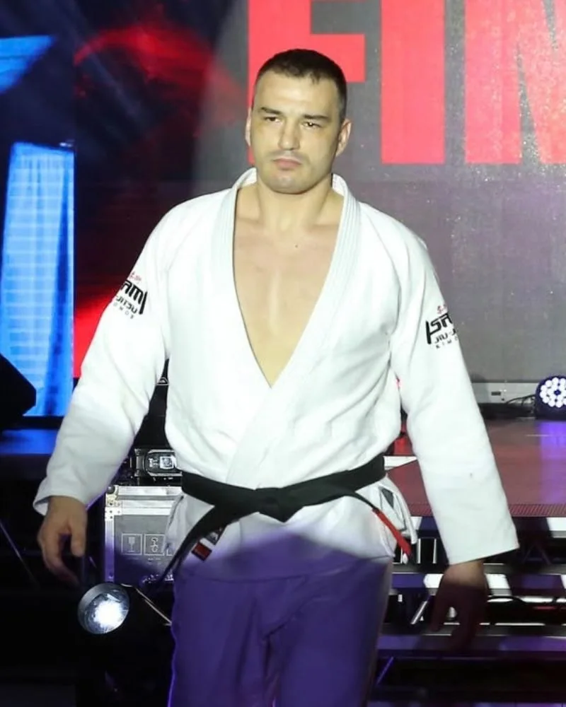 Spiro Kovac in a white gi and black belt walking out for a black belt final at the SJJIF World Jiu-Jitsu Championship